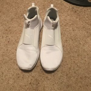 All white Puma sneakers